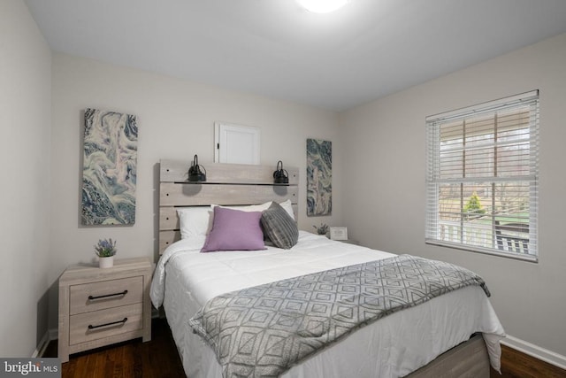 bedroom with dark hardwood / wood-style floors