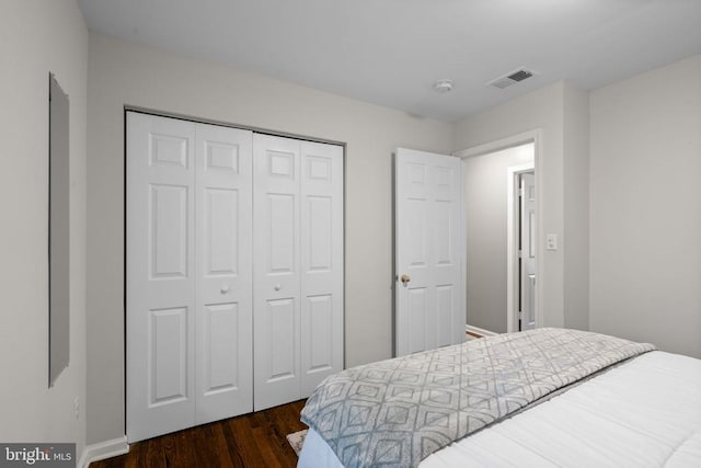 bedroom featuring a closet and dark hardwood / wood-style floors