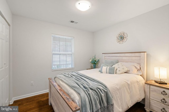 bedroom with dark hardwood / wood-style floors