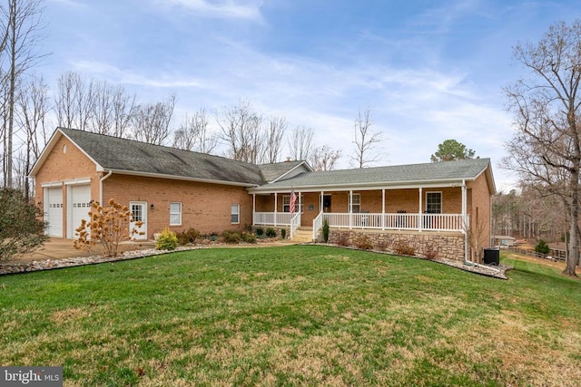 ranch-style house featuring covered porch, a garage, and a front lawn