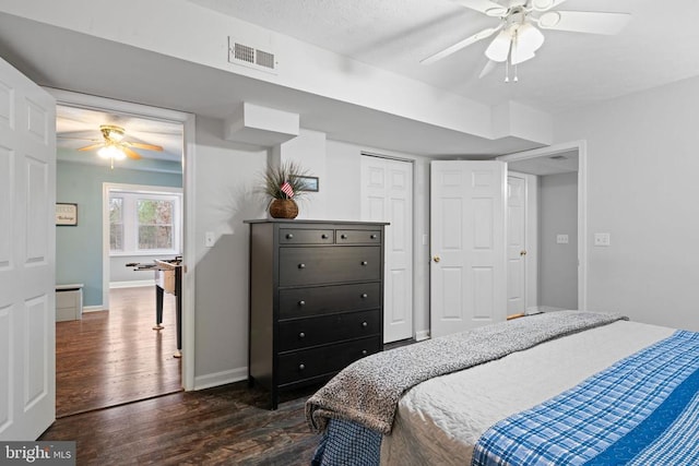 bedroom featuring ceiling fan, a closet, and dark hardwood / wood-style floors