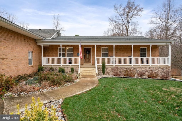 single story home featuring a porch and a front yard