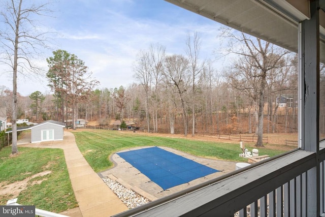 view of swimming pool with a lawn and a patio area