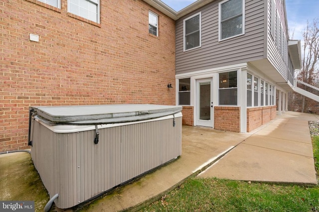 exterior space with a patio area and a hot tub