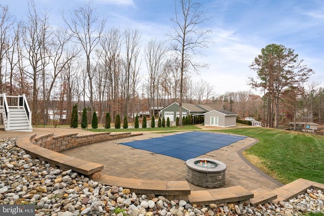 view of pool with a patio area and a yard