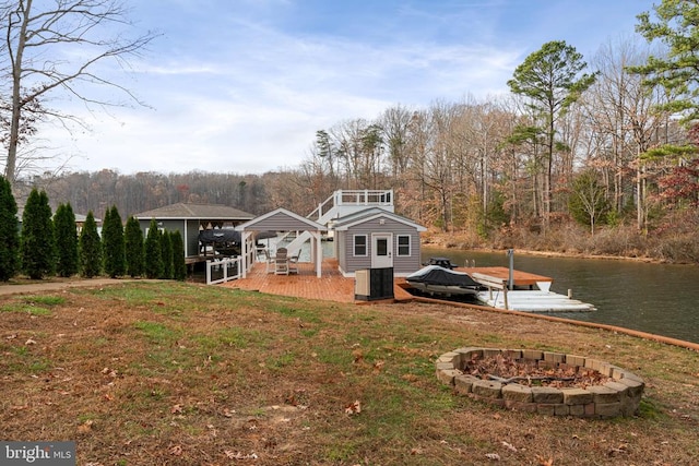 back of house featuring a water view and a yard