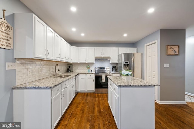 kitchen with dark wood-type flooring, sink, appliances with stainless steel finishes, a kitchen island, and white cabinetry