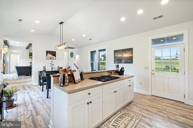 kitchen with a wealth of natural light, black gas stovetop, pendant lighting, and vaulted ceiling