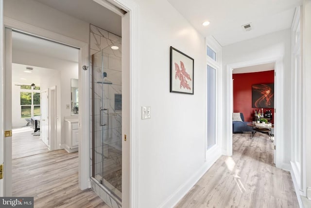 corridor featuring light hardwood / wood-style floors