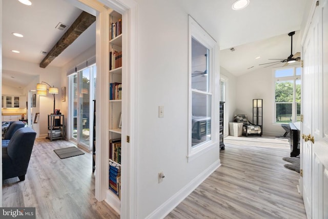 hall featuring vaulted ceiling with beams and light hardwood / wood-style floors