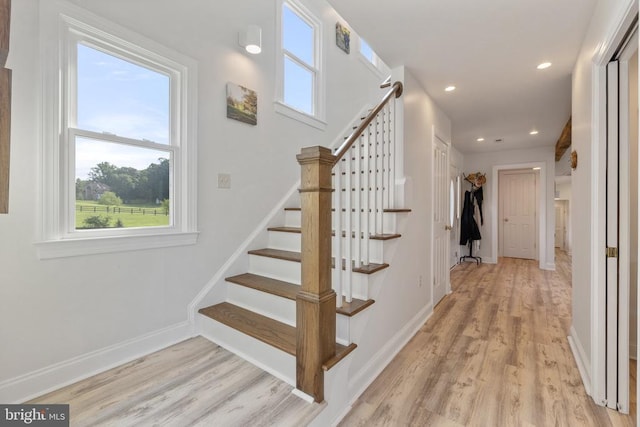 staircase featuring wood-type flooring