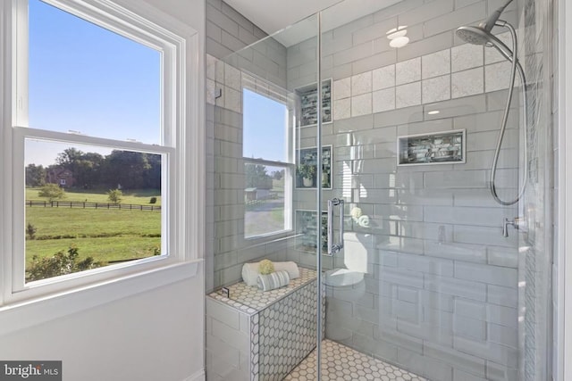 bathroom with plenty of natural light, an enclosed shower, and tile patterned flooring