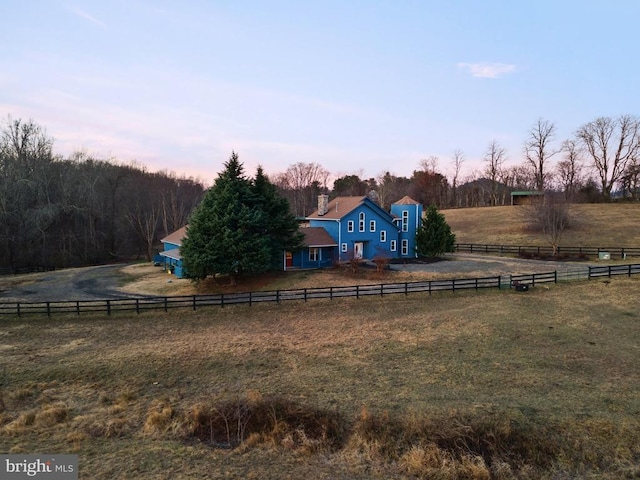 yard at dusk with a rural view