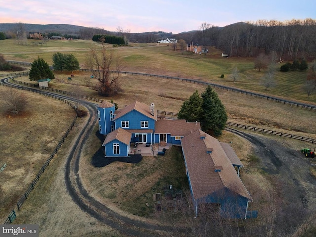 aerial view at dusk featuring a rural view