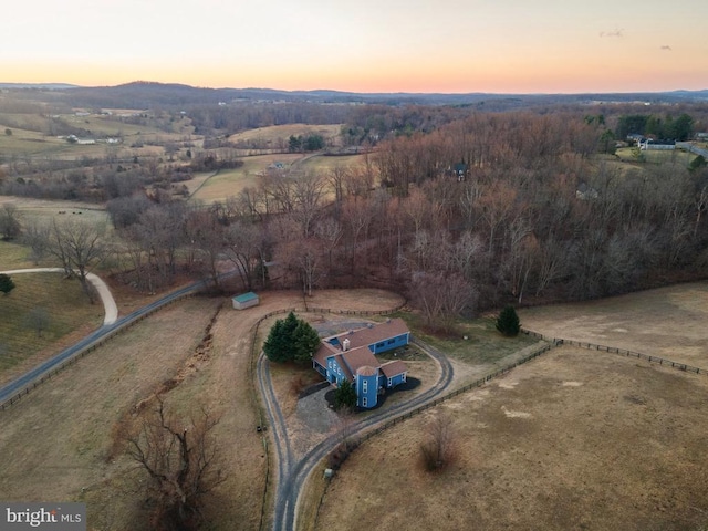 aerial view at dusk featuring a mountain view