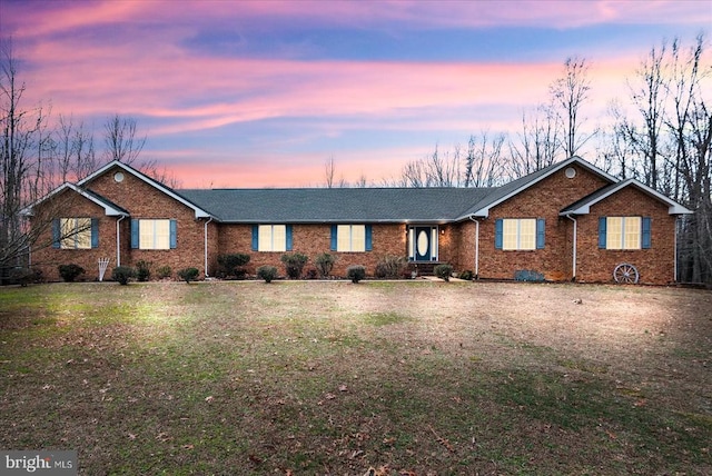 ranch-style house featuring a yard