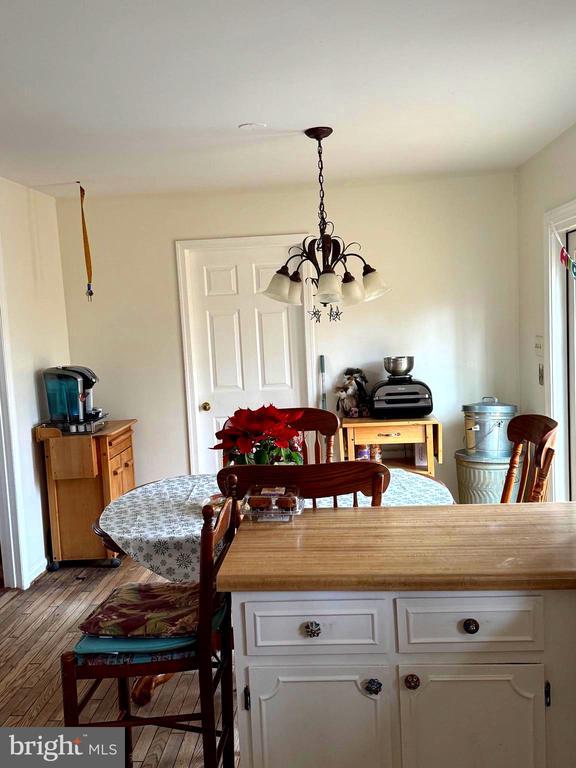 dining room featuring light wood-type flooring and an inviting chandelier