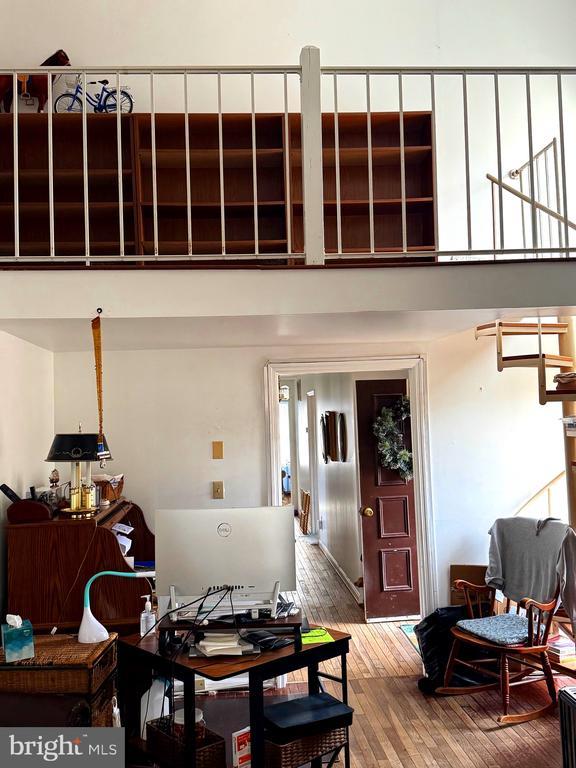 interior space with hardwood / wood-style floors and a high ceiling