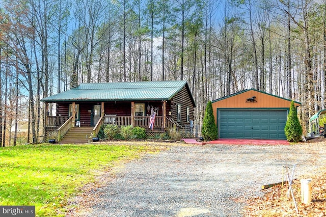 view of front of property with covered porch, a garage, a front lawn, and an outdoor structure