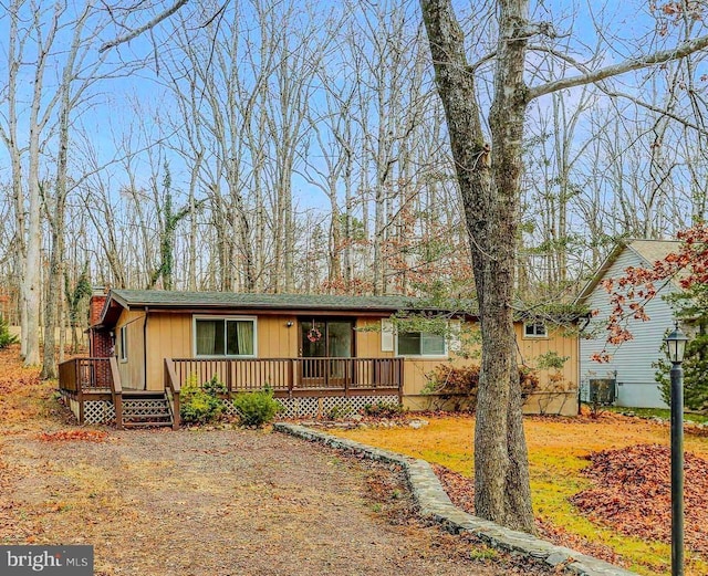 view of front of property with a deck and central AC unit