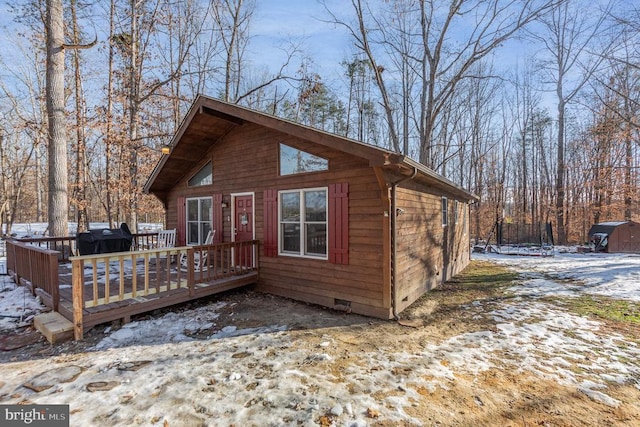 view of front of home with a trampoline and a wooden deck