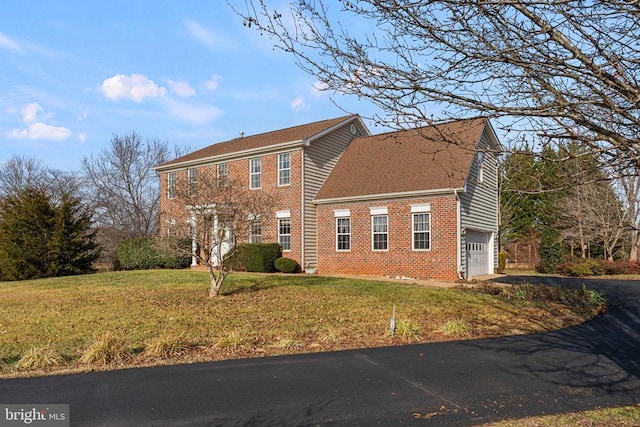 exterior space with a garage and a yard