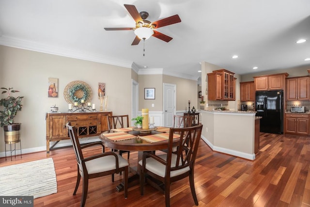 dining space with dark hardwood / wood-style floors, ceiling fan, and ornamental molding