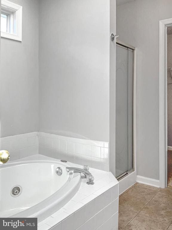 bathroom with tile patterned floors and plus walk in shower