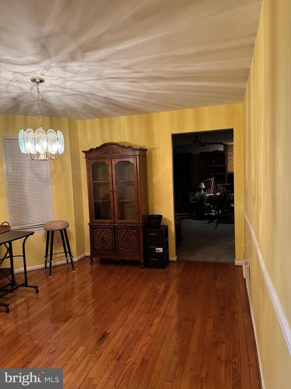 interior space with dark hardwood / wood-style floors and a notable chandelier