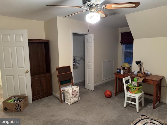 interior space with a closet, light colored carpet, a spacious closet, and ceiling fan