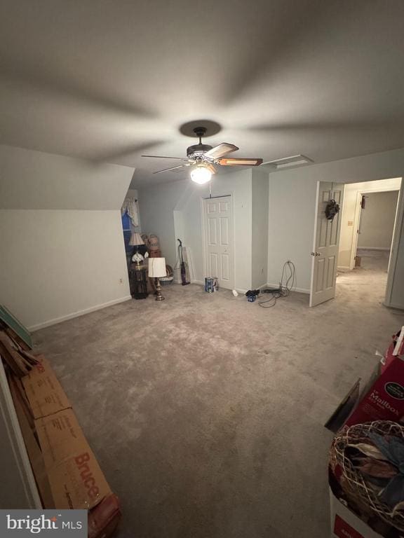 bonus room with carpet flooring, vaulted ceiling, and ceiling fan