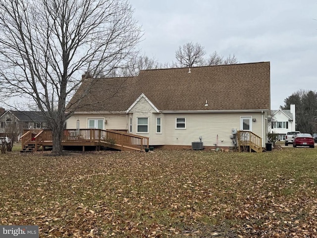 rear view of property featuring central AC unit and a deck