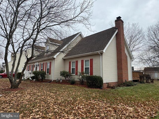 view of side of home with a yard