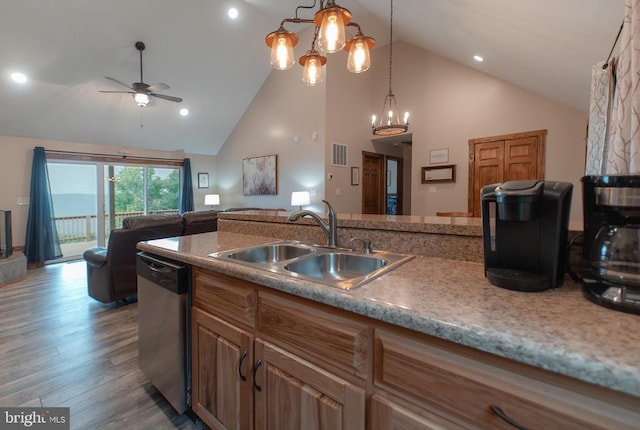 kitchen with high vaulted ceiling, ceiling fan with notable chandelier, hanging light fixtures, sink, and stainless steel dishwasher