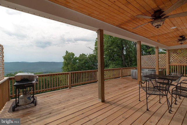 deck featuring a mountain view, ceiling fan, and a grill