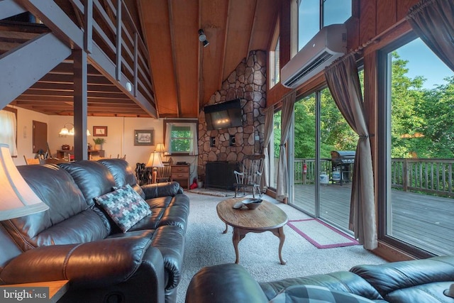 carpeted living room featuring a stone fireplace, high vaulted ceiling, and a wall mounted AC