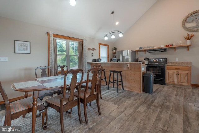 dining room with lofted ceiling and light wood-type flooring