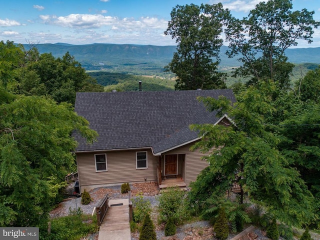 rear view of house featuring a mountain view