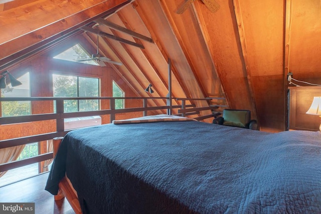 bedroom with hardwood / wood-style flooring and lofted ceiling