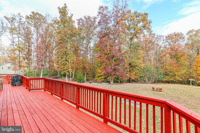 wooden deck with a lawn