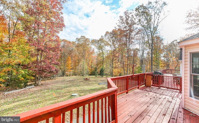 wooden deck with a lawn