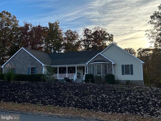 single story home with a porch