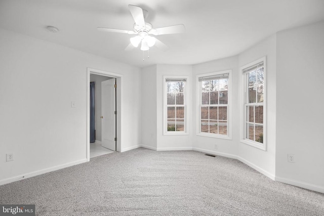 unfurnished room with ceiling fan and light colored carpet