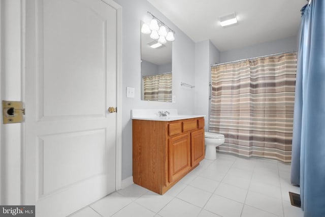 bathroom featuring a shower with curtain, tile patterned flooring, vanity, and toilet