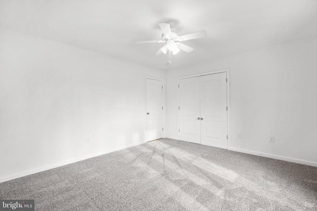 spare room featuring ceiling fan and carpet floors