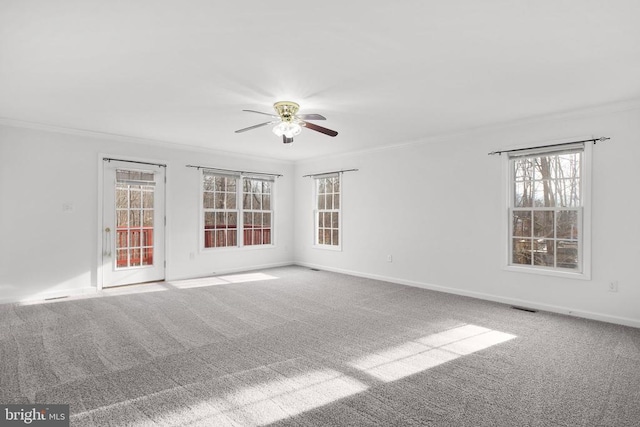 unfurnished room featuring ceiling fan, carpet floors, and ornamental molding