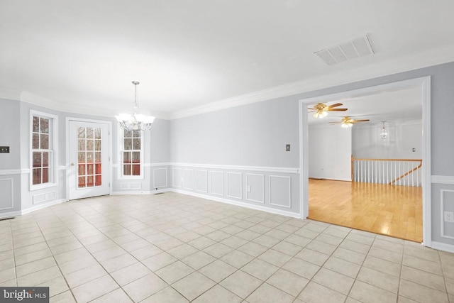 spare room with light tile patterned floors, ceiling fan with notable chandelier, and crown molding