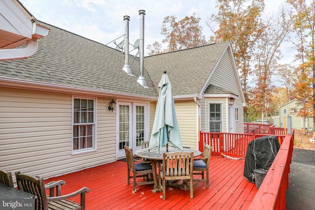 wooden deck with a grill