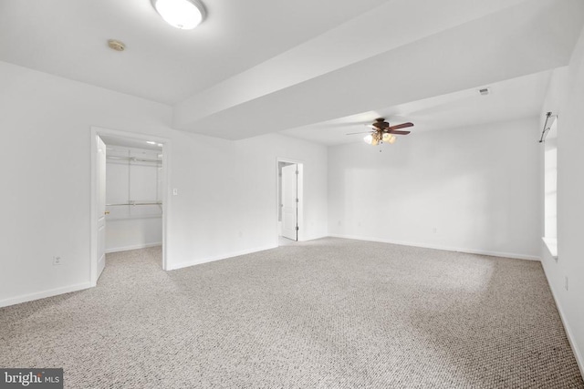 unfurnished room featuring ceiling fan and carpet floors