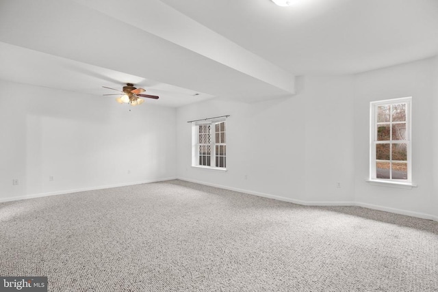 carpeted spare room featuring ceiling fan